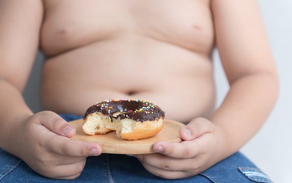 donut in hand obese fat boy.