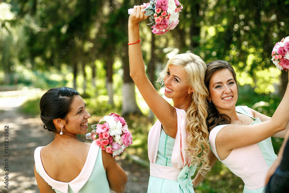 Wall mural The smilling bridesmaids with bouquets