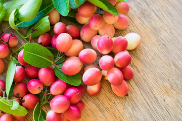 Carunda,Karonda,Carissa carandas,Apocynaceae, fruit red seed nutritious on wooden table