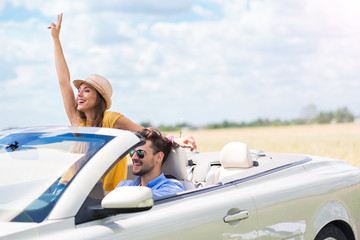 Couple enjoying a drive in a convertible

