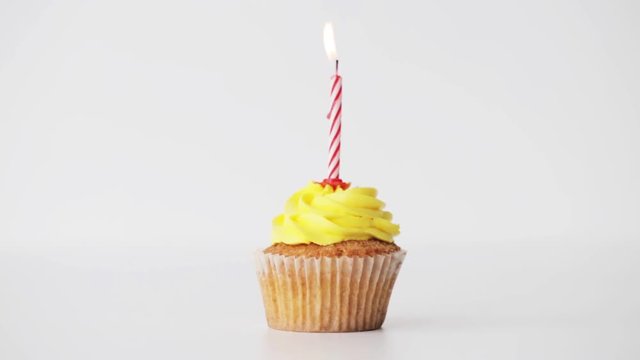 birthday cupcake with burning candle