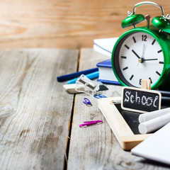 Assortment of office and school supplies on wooden table
