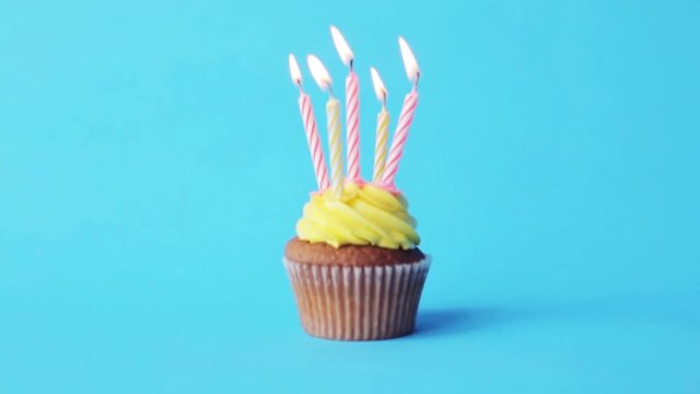 birthday cupcake with five burning candles