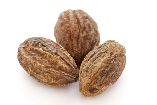 Organic dry Harad (Terminalia chebula) isolated on white background. Macro close up. Top view.