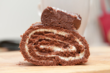 Chocolate cream cake with coffee in the background