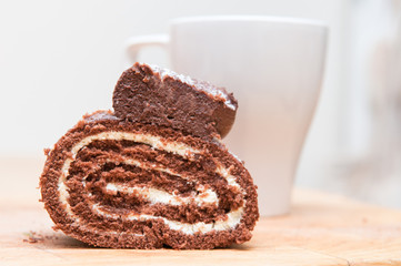 Chocolate cream cake with coffee in the background