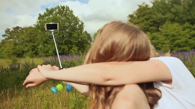 Two girls doing selfi with selfi stick