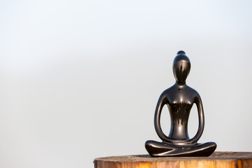 Figure of beautiful young girl meditating and do yoga on wooden surface. With empty space for text