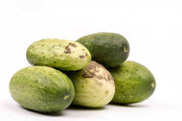 Fresh cucumbers dirty with soil isolated over white background