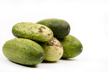 Fresh cucumbers dirty with soil isolated over white background