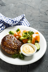 Beef burger with vegetable salad and sauce