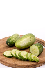 Sliced fresh cucumbers on the round cutting board