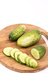 Sliced fresh cucumbers on the round cutting board