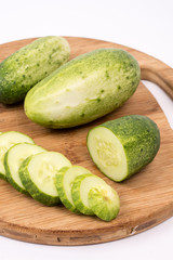 Sliced fresh cucumbers on the round cutting board