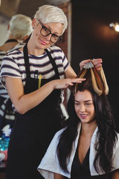 Hairdresser styling customers hair