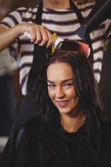Fototapeta premium Pretty woman getting her hair dried