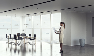 Businesswoman holding paper sheets   . Mixed media