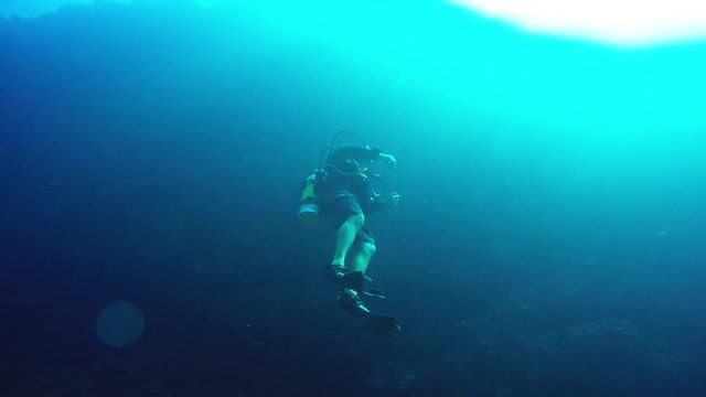 Diving Instructor hovering underwater