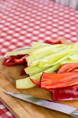 Sliced red and green paprika on the cutting board