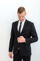 Portrait of young happy smiling business man, isolated over white background