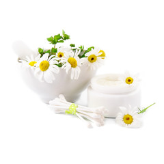 Beautiful daisies, jar of cosmetic cream and hygienic sticks on a white background.
