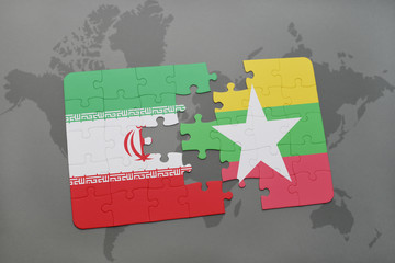 puzzle with the national flag of iran and myanmar on a world map background.