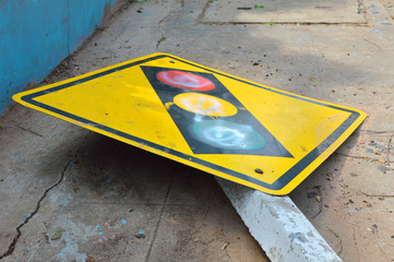 broken traffic light sign on footpath