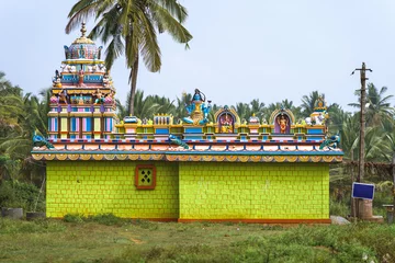 Papier Peint photo Temple Small colorful hindu temple dedicated to Lord Shiva in the Karnataka countryside, India. Side view.