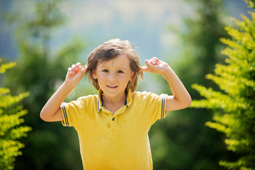 Portrait of adorable boy, making funny faces