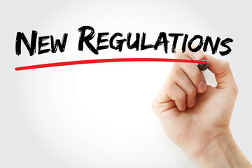 Hand writing New Regulations with marker, concept background