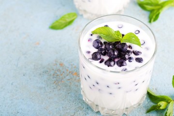 Homemade yogurt with fresh blueberries on a wooden table,selective focus