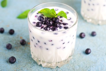 Homemade yogurt with fresh blueberries on a wooden table,selective focus
