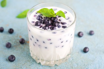 Homemade yogurt with fresh blueberries on a wooden table,selective focus