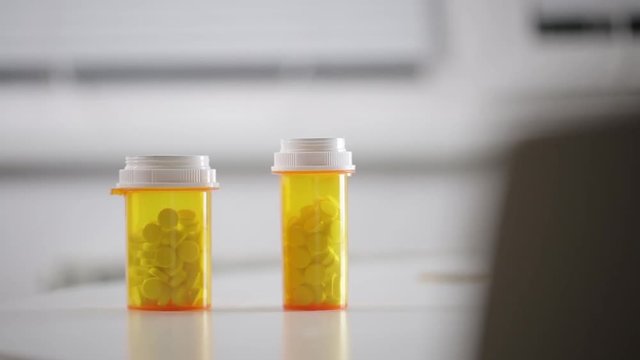 Man takes a bottle of pills on the table