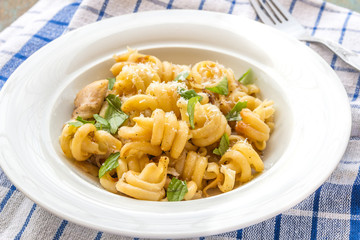Cooked tortolle pasta with basil and Parmesan cheese.