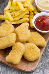 chicken nuggets with french fries and tomato sauce, closeup 