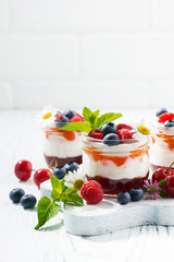 sweet dessert with jam, cream and fresh fruit, vertical