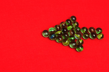 Marbles displayed in a arrow shape on red background