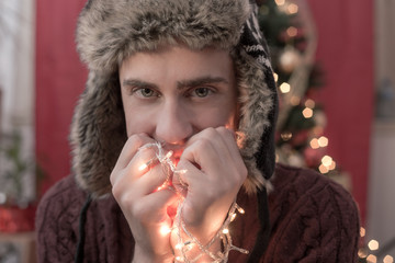 Man holding Christmas lights 