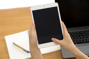 Professional businesswoman working at desk and using a touch scr