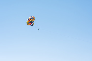Parasailing summer sport. Parachute and boat. High in the sky