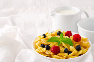 Breakfast with cereal flakes, berries, mint and milk