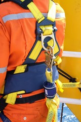 construction site worker at offshore with safety harness.