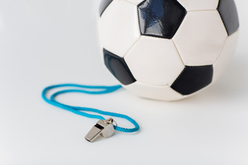 close up of football or soccer ball and whistle