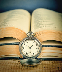 Old pocket watch and book