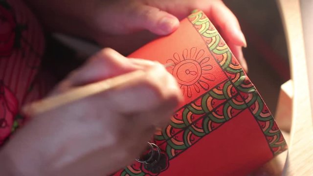paints with a brush on wood