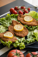 Schnitzel serve with greens and lemon