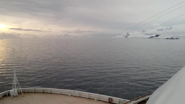 View of sunrise over Brabant Island, seen from a cruise ship. Gerlache Strait, Antarctica. 