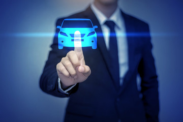 Close up of businessman touching car icon on virtual screen