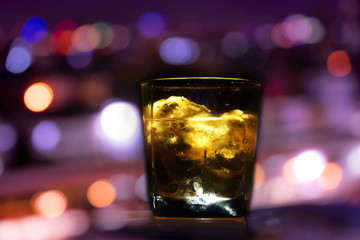 glass of whisky and lighting , on black background